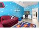 Inviting living room featuring comfortable seating, a TV, and a fun Toy Story theme at 308 Yellow Snapdragon Dr, Davenport, FL 33837