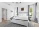 Bright main bedroom featuring a comfortable bed, wood floors, and natural light at 308 Yellow Snapdragon Dr, Davenport, FL 33837