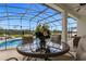 Outdoor covered patio features an outdoor table and a view of the pool at 308 Yellow Snapdragon Dr, Davenport, FL 33837