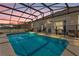 Backyard pool surrounded by a screened enclosure at sunset at 308 Yellow Snapdragon Dr, Davenport, FL 33837