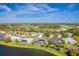 Picturesque neighborhood aerial view with lakefront homes, pools, and golf course in the distance at 3181 Bayview Ln, St Cloud, FL 34772