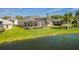 Backyard aerial view of lakeside home with a screened-in pool and well-manicured lawn at 3181 Bayview Ln, St Cloud, FL 34772