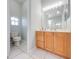 Bright bathroom featuring a vanity with wood cabinets, and a separate toilet room at 3181 Bayview Ln, St Cloud, FL 34772