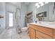Bright bathroom featuring a light wood vanity, tile flooring, and a glass-enclosed shower at 3181 Bayview Ln, St Cloud, FL 34772