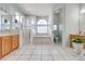 Open bathroom boasts a soaking tub, glass shower, and and vanities at 3181 Bayview Ln, St Cloud, FL 34772
