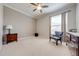 Cozy bedroom featuring neutral carpet, a window with blinds, and stylish accent furniture at 3181 Bayview Ln, St Cloud, FL 34772