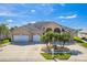 Beautiful home featuring a three-car garage, lovely landscaping, and a welcoming facade at 3181 Bayview Ln, St Cloud, FL 34772