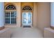 Welcoming front entrance with double doors, arched windows, and stately columns at 3181 Bayview Ln, St Cloud, FL 34772