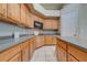 Well-lit kitchen with wooden cabinetry, granite countertops, modern appliances, and tiled floors at 3181 Bayview Ln, St Cloud, FL 34772