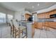 Eat-in kitchen boasts wood cabinets, a breakfast bar, and modern lighting for casual dining at 3181 Bayview Ln, St Cloud, FL 34772