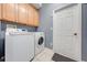 Functional laundry room featuring a washer, dryer, and storage cabinets at 3181 Bayview Ln, St Cloud, FL 34772