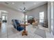Bright living room with vaulted ceiling, tile floor, transom windows, and view of the lake at 3181 Bayview Ln, St Cloud, FL 34772