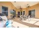 Covered patio with ceiling fans, an outdoor television, and ample seating offers comfortable outdoor living at 3181 Bayview Ln, St Cloud, FL 34772