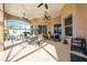 Spacious covered patio features comfortable seating, ceiling fans, and a view of the backyard at 3181 Bayview Ln, St Cloud, FL 34772