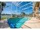 Outdoor screened-in pool area offering lake views and ample space for relaxation at 3181 Bayview Ln, St Cloud, FL 34772