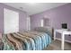 Bedroom featuring purple walls, a silver dresser and desk area at 341 Gardenia Ct, Kissimmee, FL 34759