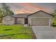 Charming single-story home with a well-maintained lawn and inviting curb appeal at 341 Gardenia Ct, Kissimmee, FL 34759