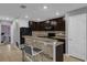 Kitchen featuring a breakfast bar, dark cabinetry, and modern appliances at 341 Gardenia Ct, Kissimmee, FL 34759