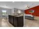 Open-concept kitchen with bar seating looking into the living room at 341 Gardenia Ct, Kissimmee, FL 34759