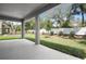 Open back porch with concrete flooring offers great views of the backyard and white fence at 3765 Deer Ridge Dr, Mount Dora, FL 32757