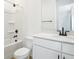 Modern bathroom featuring a shower-tub, black fixtures, and light cabinets at 3765 Deer Ridge Dr, Mount Dora, FL 32757