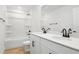 Bathroom featuring double sinks with black fixtures, a tub, and neutral flooring at 3765 Deer Ridge Dr, Mount Dora, FL 32757