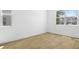 Bright, empty bedroom with wood-look tile flooring and plenty of natural light at 3765 Deer Ridge Dr, Mount Dora, FL 32757