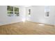 Bright, empty bedroom with wood-look tile flooring and multiple windows for ample natural light at 3765 Deer Ridge Dr, Mount Dora, FL 32757