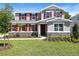 Charming two-story home with red shutters and stone accents surrounded by a lush, green lawn at 3765 Deer Ridge Dr, Mount Dora, FL 32757
