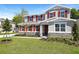 Charming two-story home with red shutters and stone accents surrounded by a lush, green lawn at 3765 Deer Ridge Dr, Mount Dora, FL 32757