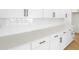 Modern white kitchen cabinets with stainless steel appliances and elegant countertops at 3765 Deer Ridge Dr, Mount Dora, FL 32757