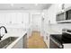 Bright, white kitchen features modern appliances, a large center island, and stylish backsplash at 3765 Deer Ridge Dr, Mount Dora, FL 32757