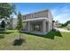 Rear exterior view of a two-story home featuring gray siding and a covered patio with sliding doors at 3765 Deer Ridge Dr, Mount Dora, FL 32757