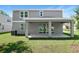 Two-story home with gray siding, a covered patio, and sliding glass doors leading to the backyard at 3765 Deer Ridge Dr, Mount Dora, FL 32757