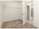 Walk-in closet with carpet and metal shelving, leads to tiled bathroom at 4928 Worchester Dr, Kissimmee, FL 34746