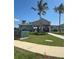 Community pool house with manicured landscaping and palm trees on a sunny day at 4928 Worchester Dr, Kissimmee, FL 34746