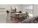 Dining area with modern table, stylish decor, and sliding doors to the backyard at 4928 Worchester Dr, Kissimmee, FL 34746