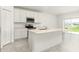 Bright kitchen featuring a center island, stainless steel appliances, and views of the backyard at 4928 Worchester Dr, Kissimmee, FL 34746