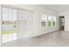 Bright living room featuring tile floors, a view of the lake, and three large windows at 4928 Worchester Dr, Kissimmee, FL 34746