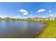 Scenic pond view in the neighborhood, featuring blue sky and green grass at 4928 Worchester Dr, Kissimmee, FL 34746