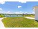 Scenic view of a pond surrounded by lush green grass and neighborhood homes at 4928 Worchester Dr, Kissimmee, FL 34746