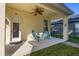 Inviting back porch with ceiling fan and cozy blue Adirondack chairs at 6821 Cultivation Way, Winter Garden, FL 34787