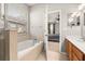 Bathroom featuring a soaking tub, tiled surround, natural light, and a door to the bedroom at 6821 Cultivation Way, Winter Garden, FL 34787