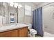 Bathroom with a shower and tub combination, single vanity, and blue shower curtain at 6821 Cultivation Way, Winter Garden, FL 34787