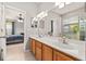 Bright bathroom with a double vanity, large mirror, updated fixtures, and access to the bedroom at 6821 Cultivation Way, Winter Garden, FL 34787