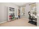 Bedroom featuring two large bookcases and a desk, ideal for an office space or study area at 6821 Cultivation Way, Winter Garden, FL 34787