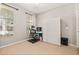 Bedroom with large window, closet and neutral carpet, perfect for a home office at 6821 Cultivation Way, Winter Garden, FL 34787