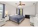 Comfortable bedroom featuring a queen-sized bed, soothing color palette, and ample natural light from the window at 6821 Cultivation Way, Winter Garden, FL 34787