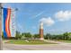 Community clock tower with manicured landscaping and an Independence flag at 6821 Cultivation Way, Winter Garden, FL 34787