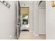 Entryway featuring tiled floors, a coat rack, and a view through the open front door to the porch beyond at 6821 Cultivation Way, Winter Garden, FL 34787